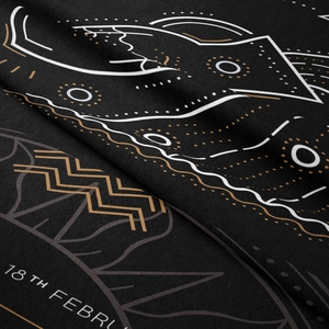 Macro detail showing the fiber texture and constellations printed on black bohemian tapestry