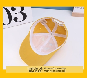 Detailed interior of yellow cotton kids baseball cap showing fine stitching and label