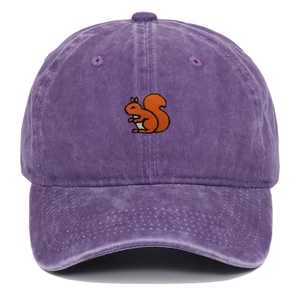 Detail of purple washed cotton baseball cap with orange squirrel embroidery and distressed texture