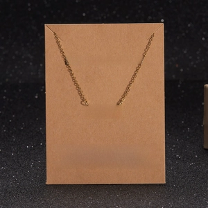 Close-up of gold MOM heart pendant necklace displayed on a Make a Wish gift card