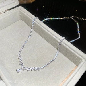 Detail of silver drop necklace with zircon stones in a premium velvet jewelry box