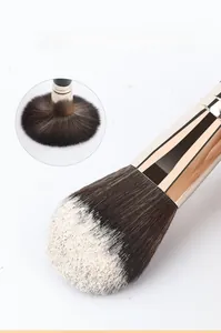 Detail of dense makeup brush bristles with strong powder grip and gold ferrule