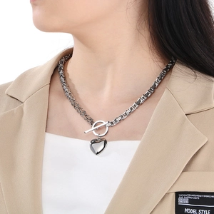 Detail of silver heart pendant on a chunky Byzantine chain with OT toggle clasp