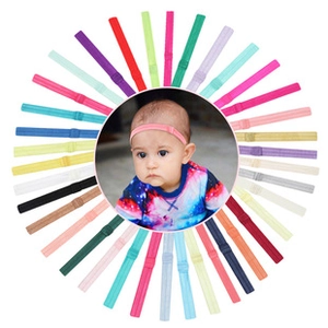 Macro detail of assorted colorful ribbed fabric bow headbands for infants in circular layout