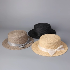 Three raffia flat top boater hats in grey, black and beige with silk bow ribbons