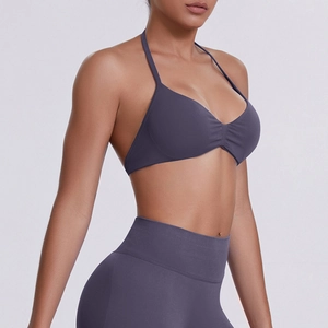 Detail view of seamless high-stretch sports bra and leggings set in deep purple matte fabric