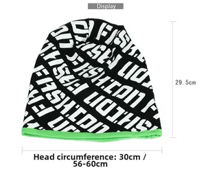 Detail of black knit beanie with white letters and lime green trim showing size dimensions