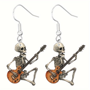 Detail of gothic rock skeleton acrylic earrings featuring a skull playing guitar