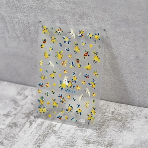 Close-up of thin nail stickers with Chinese jade rabbit and floral motifs on stone background