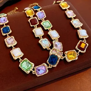 Vintage gold-plated necklace featuring square-cut multi-color crystals on brown velvet