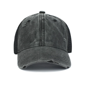 Detailed close-up of vintage washed cotton cap with distressed holes and mesh back