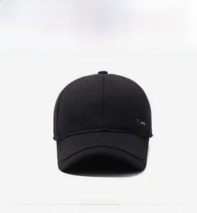 Detailed macro view of black winter baseball cap featuring textured wool and SPORT metal plaque