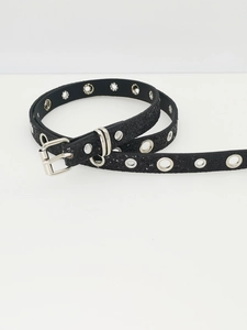Detail of black Y2K belt featuring sparkling sequins, silver buckle and metal eyelets