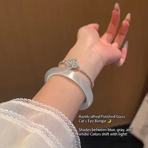 Bracelet jonc en verre œil de chat et bracelet à fleurs étincelant sur poignet féminin