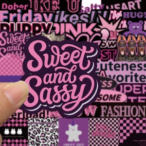 Close-up of a pink 'Sweet and Sassy' sticker being held to show texture and size