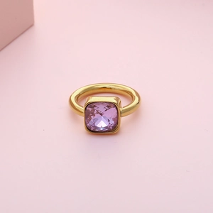 Elegant gold titanium steel ring featuring a square purple zircon gemstone on pink background