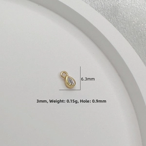 Detailed view of tiny 925 silver pear drop pendant with clear cubic zirconia in gold