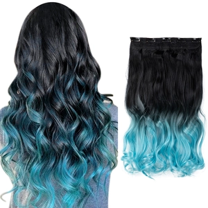 Detail showing wavy black to teal ombre hair extensions with five sturdy metal clips