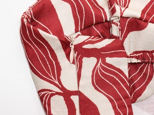 Detail of red and white abstract floral print with invisible zipper and fine stitching