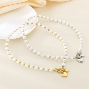 Elegant pearl and bead jewelry set with heart pendant and OT toggle clasp on silk fabric