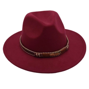 Detail of burgundy wool felt jazz hat with golden feather metal and bead decorations
