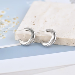 Polished S925 silver croissant hoop earrings with vintage texture on marble background