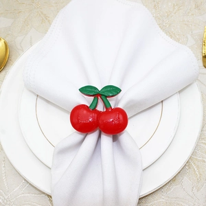 Macro shot of red cherry napkin ring on a white cloth on a plate for table decor