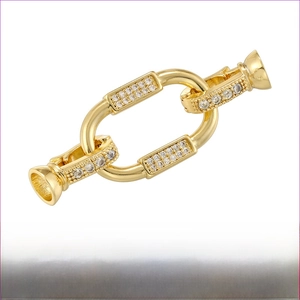 Macro detail of gold plated brass jewelry clasp with sparkling cubic zirconia inlay