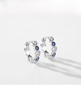 Detail of S925 silver hoop earrings with blue evil eye charms and heart zircon stones