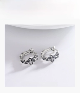Close-up of S925 sterling silver gothic cross ring with micro-set diamonds and floral engravings