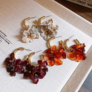 Detail of vintage flower cluster earrings in amber, cream, and red resin finishes