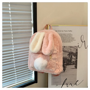 Detailed view of the soft pink plush bunny backpack with long ears and fluffy tail