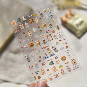 Detail of 3D embossed nail art stickers featuring breakfast bears and food motifs