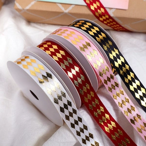 Golden rhombic pattern ribbons in white, red, pink, and black for gift wrapping decor