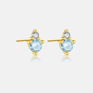 Close-up of S925 silver gold-plated stud earrings with sky blue and clear crystal stones