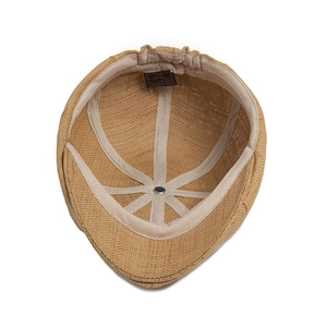 Inside view of a khaki straw newsboy cap with inner sweatband and stitching details