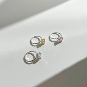 Close-up of heart-cut gems in yellow, pink and white on S925 silver rings