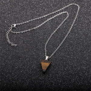 Detailed top view of a brown triangular tiger eye stone pendant on a silver metal chain