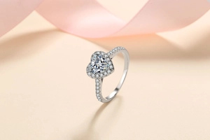Macro detail of a heart-shaped moissanite silver ring with a sparkling halo setting