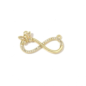Detailed close-up of golden infinity charm with butterfly and sparkling cubic zirconia stones