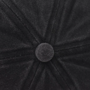 Macro shot of black washed cotton baseball cap crown with six-panel design and top button