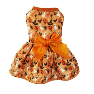 Detail of Halloween pet dress featuring pumpkin prints and a large orange satin bow