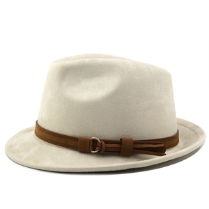 Close-up of beige suede fedora featuring a dark brown band and elegant gold ring buckle