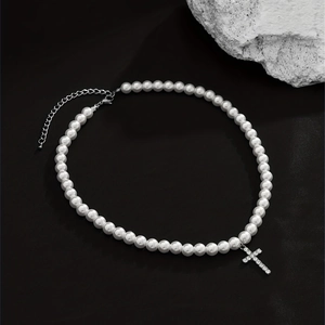 Close-up of hip hop pearl necklace featuring a silver cross pendant with diamonds