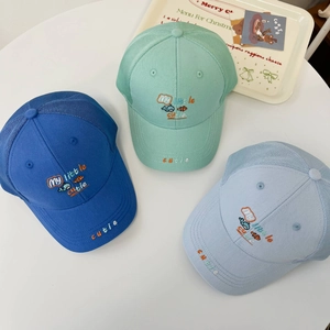 Detail of kids mesh trucker hats showing breathable polyester mesh and fish embroidery