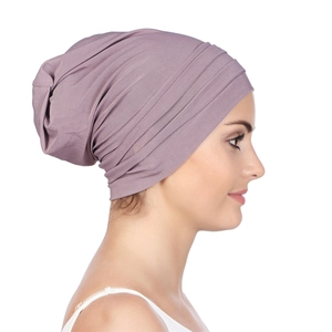 Detail view of the pleat texture and high elastic fabric on a purple chemo turban