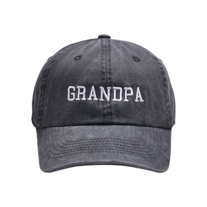 Close-up of white GRANDPA embroidery on a vintage washed black cotton baseball cap