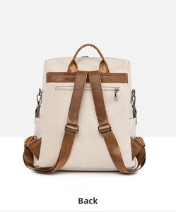 Detail view of the backpack back featuring a hidden anti-theft zipper pocket and brown straps