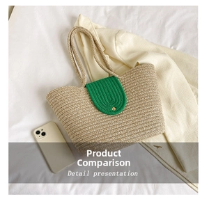 Detail view of woven straw tote bag with green oval flap and gold buckle closure