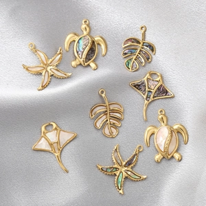 Golden sea life pendants with natural shell inlays of sea turtle and starfish